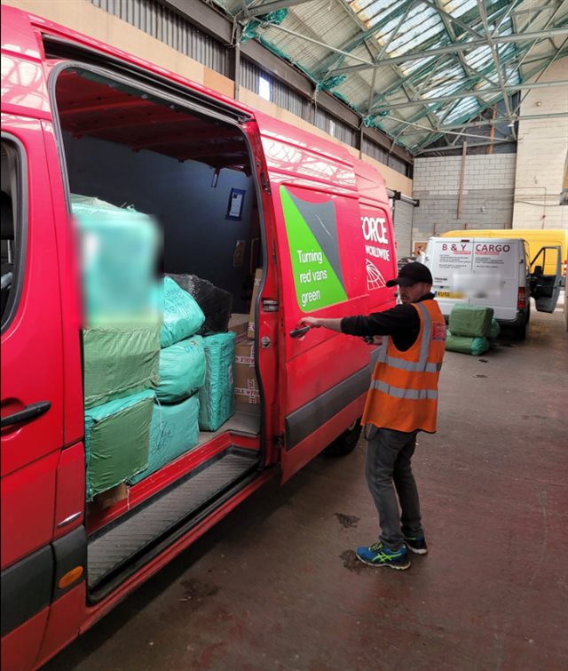 Loading cargo bales into a delivery van at the B&Y Cargo depot