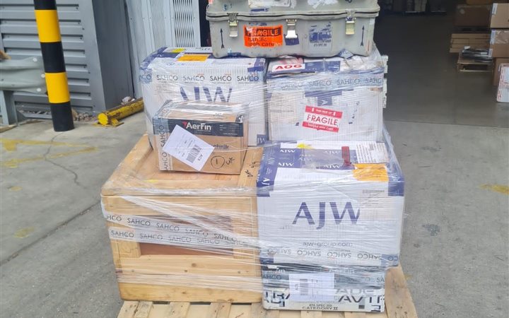 Shrink-wrapped commercial cargo pallet at a secure loading bay